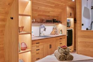 a small kitchen with wooden cabinets and a sink at ~* The Spectacular Spyglass Treehouse *~ in Occidental