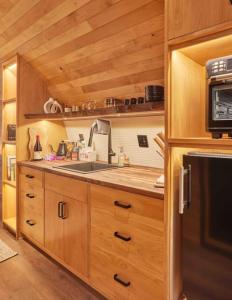 a kitchen with wooden cabinets and a sink at ~* The Spectacular Spyglass Treehouse *~ in Occidental