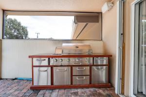 a kitchen with a stove and a window at 3BR Pool Villa on Golf Course Huge Yard & Games in Wellington