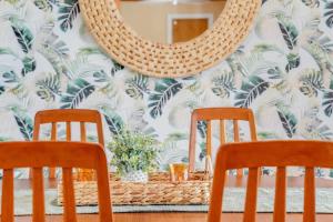 a mirror on a wall with two chairs and a table at 3BR Pool Villa on Golf Course Huge Yard & Games in Wellington