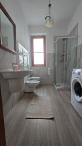 a bathroom with a toilet and a sink and a shower at Casa Vacanze Maurella in Marconia