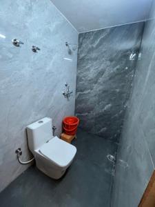 a bathroom with a toilet and a shower at Hotel ranjeet in Alīgarh