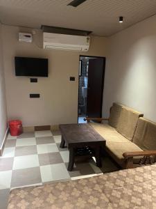 a living room with a couch and a table at Hotel ranjeet in Alīgarh