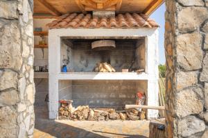 a brick oven with a fire in it at My Dalmatia - Villa Mandorla with private pool and Jacuzzi in Zadar
