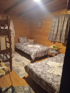 a room with two beds and a bunk bed at Vanilla House in Ulcinj