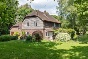an old house in a field of green grass at Westerlands Farm in Graffham