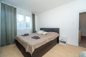 a bedroom with a bed with two towels on it at Nesporova Apartment in Košice