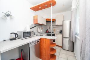a kitchen with white cabinets and a counter top at Nesporova Apartment in Košice