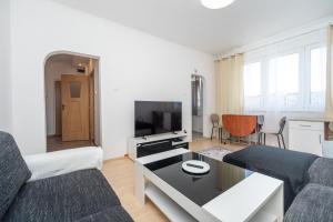 a living room with a couch and a table at Nesporova Apartment in Košice