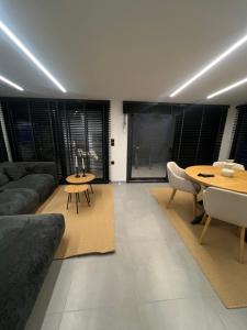 a living room with a couch and a table at BK Apartment in Xanthi
