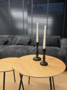 a table with two candles on it in a living room at BK Apartment in Xanthi