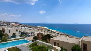 a view of the ocean from a building at Green Coast Pearl Suites Apartments Palase in Palasë
