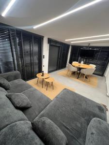 a living room with a couch and a table at BK Apartment in Xanthi +40 photos