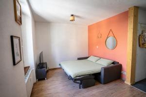 a bedroom with a bed and a mirror on the wall at T2 centre Ville Proche des pistes in Briançon