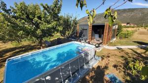 a swimming pool in the backyard of a house at Resort-Music Mostar in Potoci