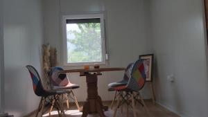 a table and four chairs in a room with a window at Resort-Music Mostar in Potoci +3 photos