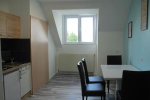a kitchen with a table and chairs and a window at Royal Racing Suite Top 5 near Red Bull Ring in Judenburg