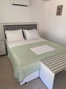 a bedroom with a bed with a green comforter at Adam House-Castle view in Toroni