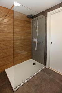 a shower with a glass door in a bathroom at Old town Bol apartments in Bol +12 photos