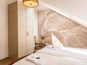 a bedroom with a bed with a wall mural at Pod Kolumnami in Pilica