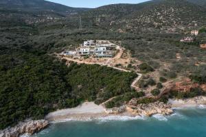 an aerial view of a house on a hill next to the ocean at Villa Thymari in Xiropigado