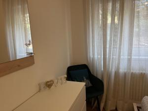 a room with a desk and a chair and a window at Lake Apartment Ischia Green, Lago di Caldonazzo in Tenna  +25 photos