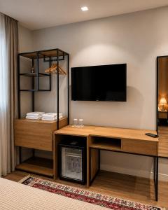 a living room with a flat screen tv on the wall at 313 Villa City Center in Tirana