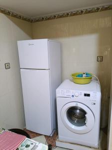 a white refrigerator and a washing machine in a kitchen at Set in Taza +6 photos