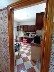 a kitchen with a checkered floor at Set in Taza