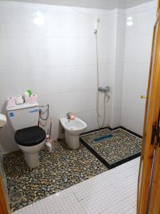 a bathroom with a toilet and a bidet at Set in Taza