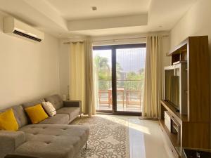 a living room with a couch and a television at Bait Al Marina in Salalah
