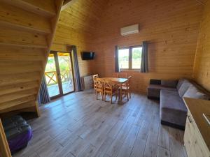 a living room with a table and a couch at Łąkowe Zacisze - Kozin in Bogaczewo