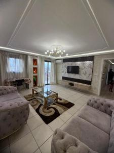 a living room with two couches and a television at Etienne Gae 2 in Douala