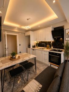 a kitchen with a couch and a table in a room at Mahal house in Pelitli +5 photos