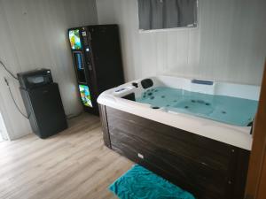 a bathroom with a jacuzzi tub in a room at Suite DT4 in Blotzheim