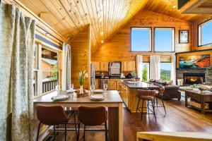 a kitchen and living room in a log cabin at Heavenly Daze Amazing Mountain View, Hot Tub, Game Room! in Sevierville