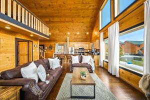 a living room with a couch and a table at Heavenly Daze Amazing Mountain View, Hot Tub, Game Room! in Sevierville