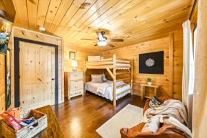 a bedroom with a bed in a wooden cabin at Heavenly Daze Amazing Mountain View, Hot Tub, Game Room! in Sevierville