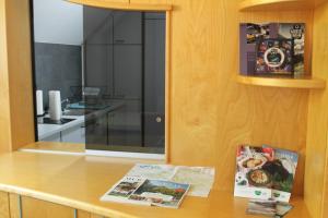 a kitchen with a counter with a book on it at Royal Racing Suite Top 1 near Red Bull Ring in Judenburg