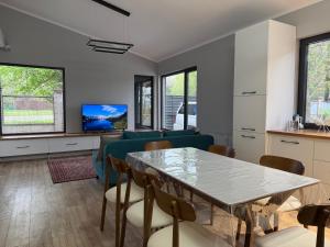 a living room with a table and a couch at Ala-Archa Mountain House in Vorontsovskoye