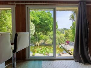 a window in a room with a view of a pond at La suite mahradja in Quimper