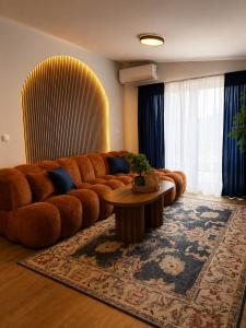 a living room with a brown couch and a table at Monti Wellness & Spa Vlašić in Vlasic