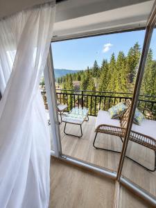 a balcony with a view of the mountains at Monti Wellness & Spa Vlašić in Vlasic