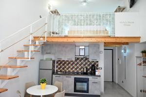 a kitchen with a loft conversion with a table at Victry's Houses Chiaia in Naples