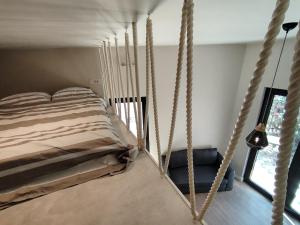 a bedroom with a bed and a rope swing at Mini Condos 2 Studio-Loft with garden in Mrčevac