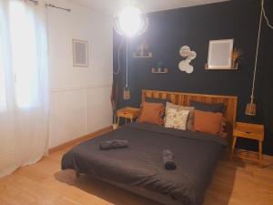 a bedroom with a bed with a gray comforter at Oasis in Agen