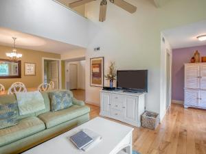 a living room with a couch and a flat screen tv at 1248 Creekwatch Villa in Seabrook Island