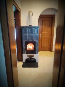 a woodburning stove in a room with a door at Haus Enzian in Mittersill +57 photos