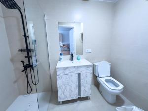 a bathroom with a toilet and a sink and a shower at Bungalow and private XXL Terrace in Alicante +55 photos