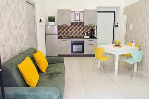a living room with a couch and a table with chairs at Victry's Houses Chiaia in Naples +60 photos